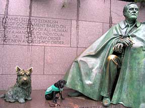 Cynthia sitting next to oversized bronze statues of Roosevelt and his scottie dog