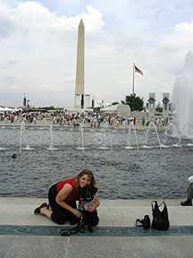 Marilkay and Cynthia sitting at the fountain's edge with the Washington Moument in the background