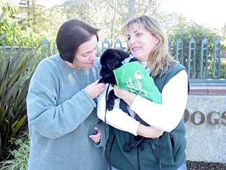 Bev and Marikay with Cynthia in front of the Guide Dogs entrance sign