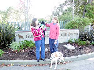 Trish and Bindy with Cynthia in front of the Guide Dogs entrance sign